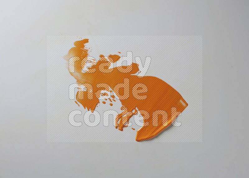 An orange single random painting knife stroke on white background