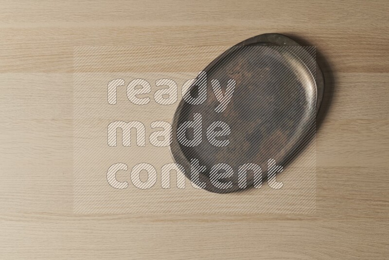 A vintage metal tray on light wooden background