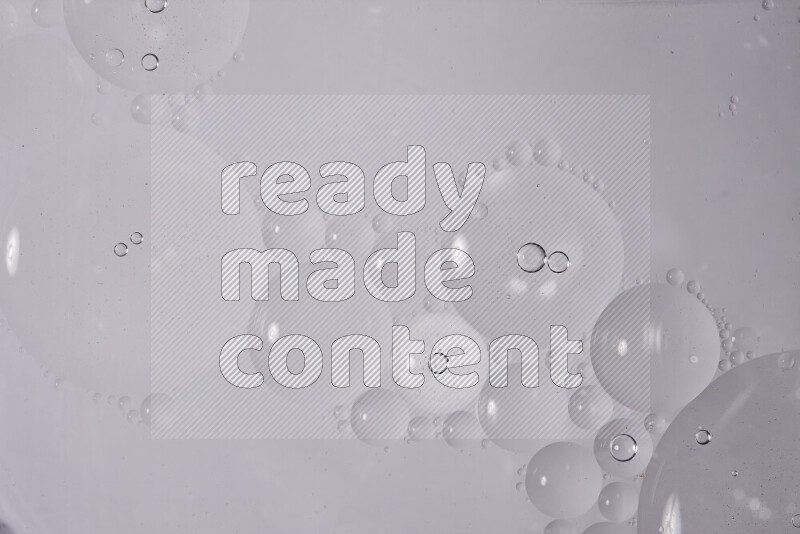 Abstract oil droplets in a water surface on white background