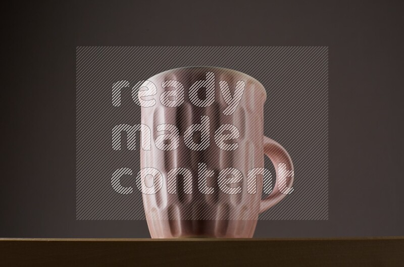 Low angle shot of a pink cup on grey background