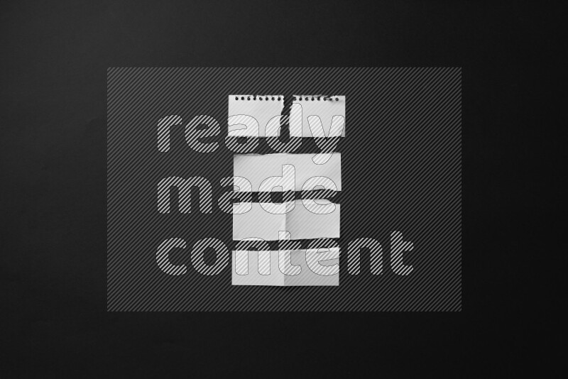 Ripped notebook sheet on black background