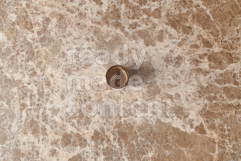 A pottery cup on beige marble background