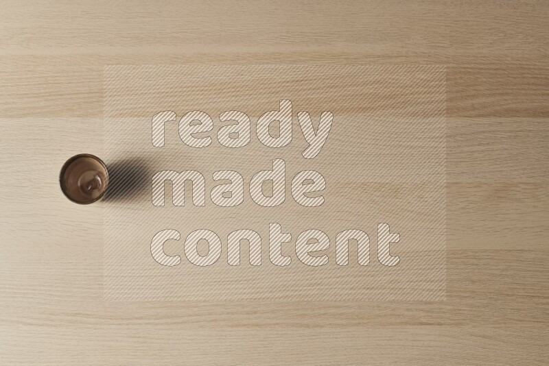 A pottery cup on light wooden background