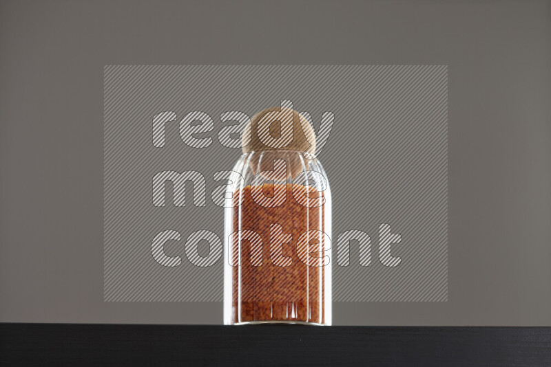 Lentils in a glass jar on black background