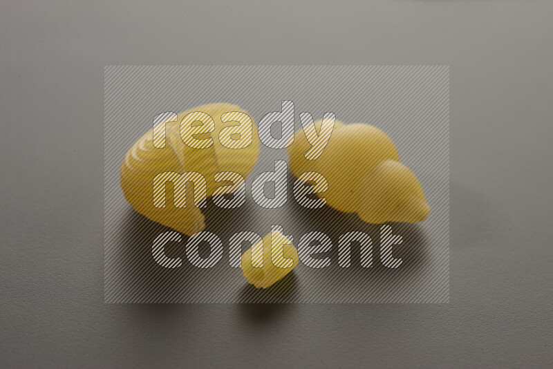 Different pasta types on grey background