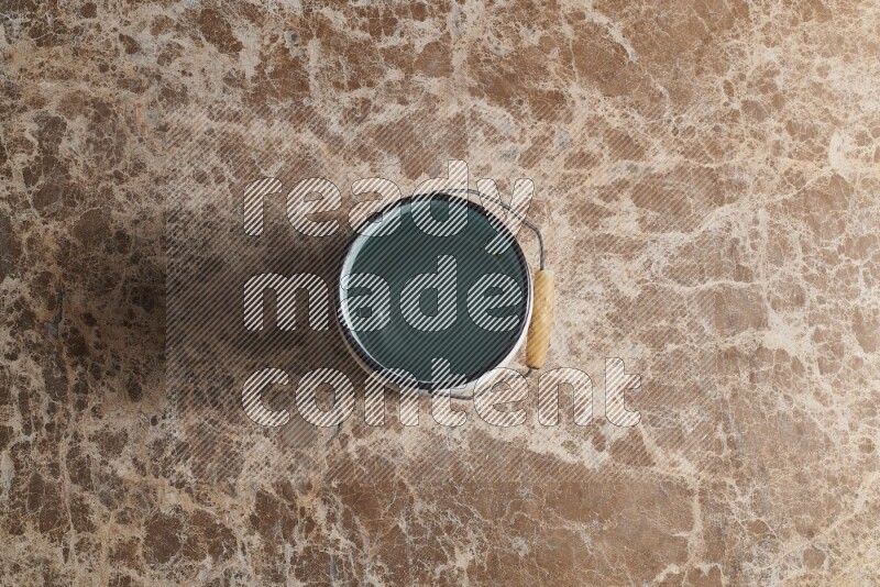 A vintage milk can on beige marble background