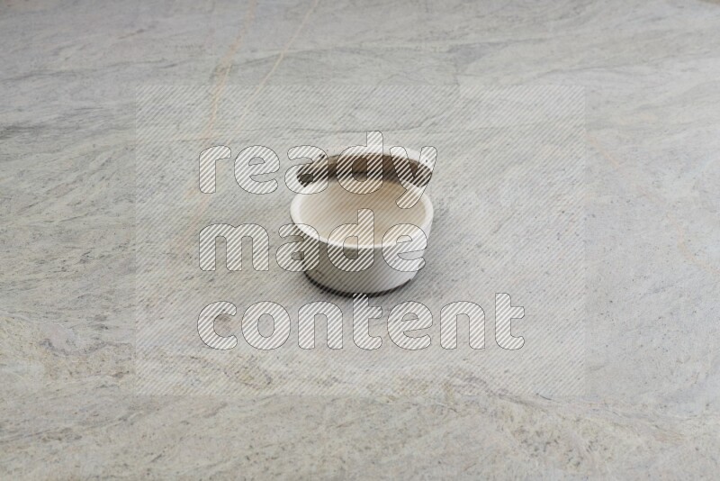 A white pottery bowl on grey marble background