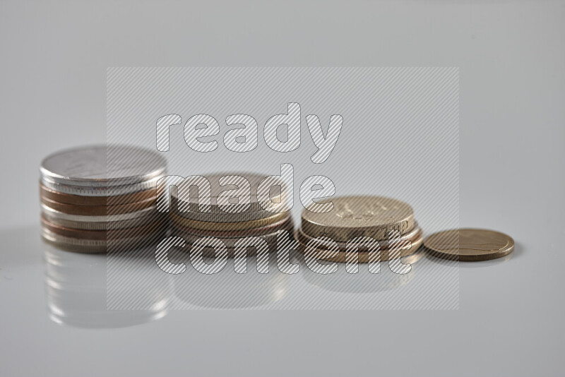 Random old coins on grey background