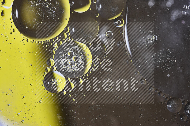 Close-ups of abstract oil bubbles on water surface in shades of yellow and brown