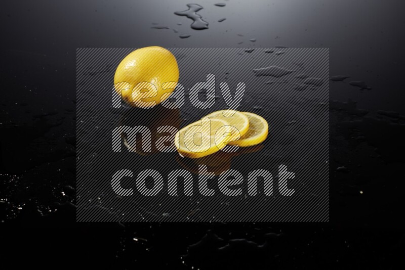 Lemon slices with water drops, and droplets on black background