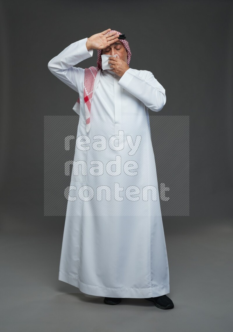 Saudi man with shomag Standing feeling sick on gray background