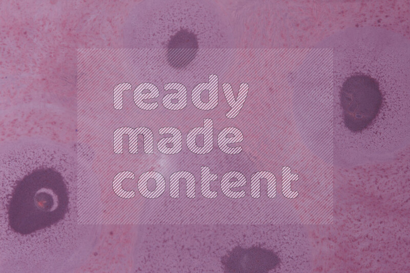 The image captures a dramatic splatter of purple paint over a white backdrop