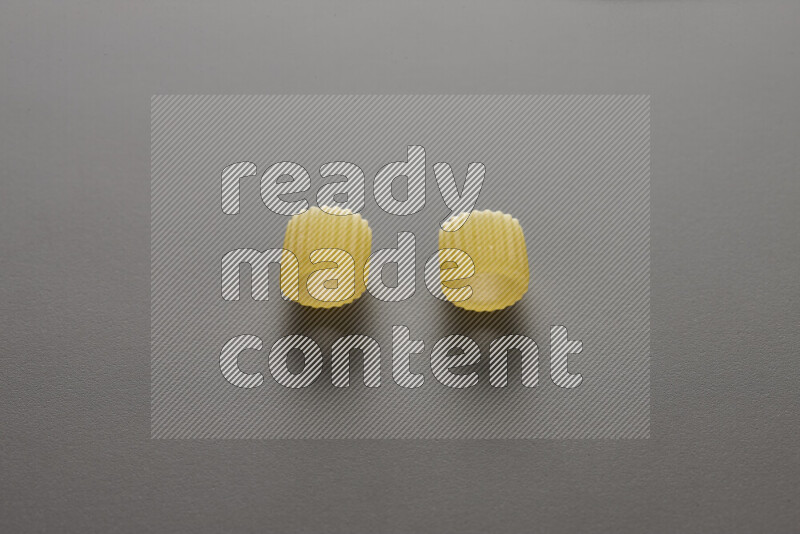 Big rings pasta on grey background