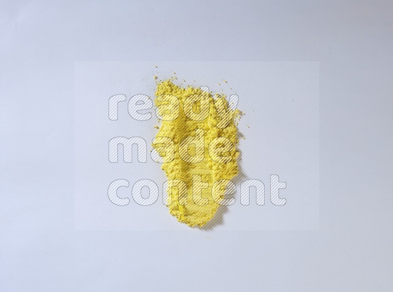 Yellow powder smears on white background