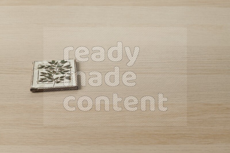 A decorative coaster on light wooden background