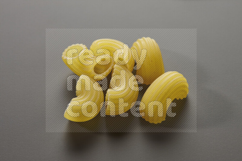 Elbow pasta on grey background