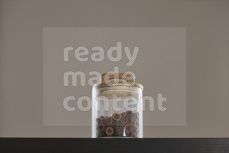 Buttons in a glass jar on black background