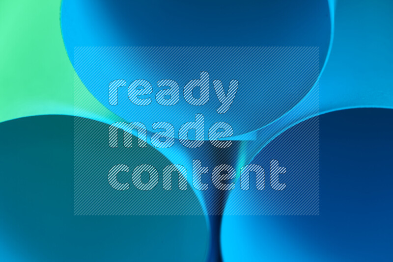 The image shows an abstract paper art with circular shapes in varying shades of green and blue