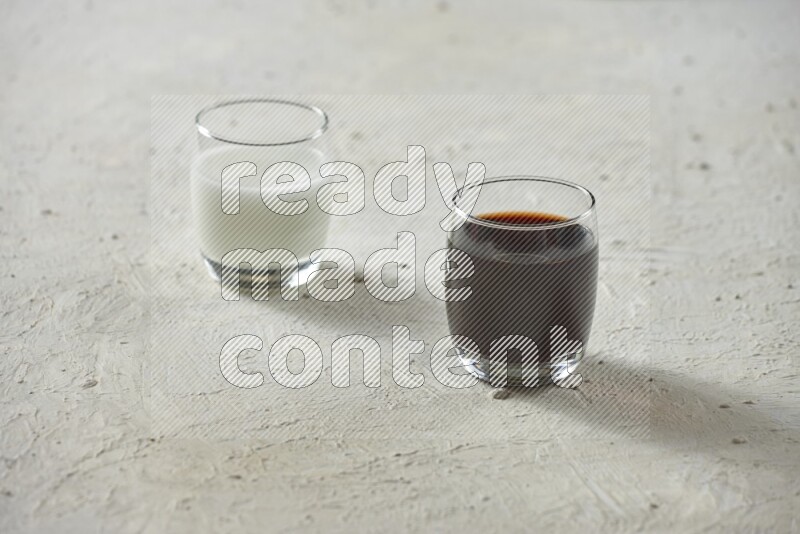 Cold drinks in a glass cup such as water, tamarind, qamar eldin, sobia, milk and hibiscus on textured white background