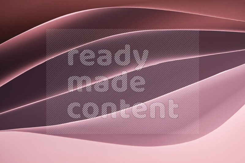 This image showcases an abstract paper art composition with paper curves in different warm gradients created by colored light