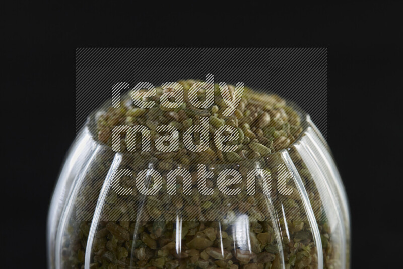 Freekeh in a glass jar on black background
