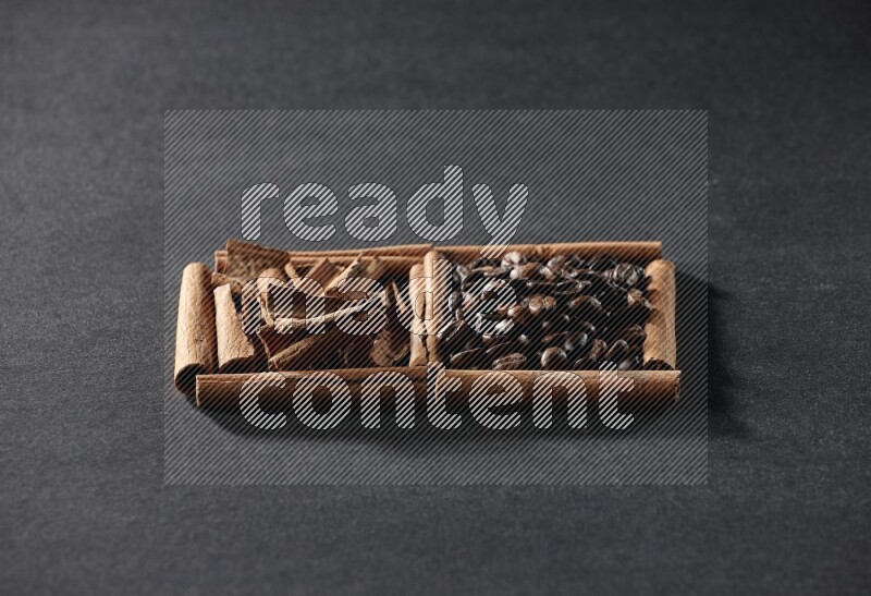 2 squares of cinnamon sticks full of coffee beans and cinnamon on black flooring