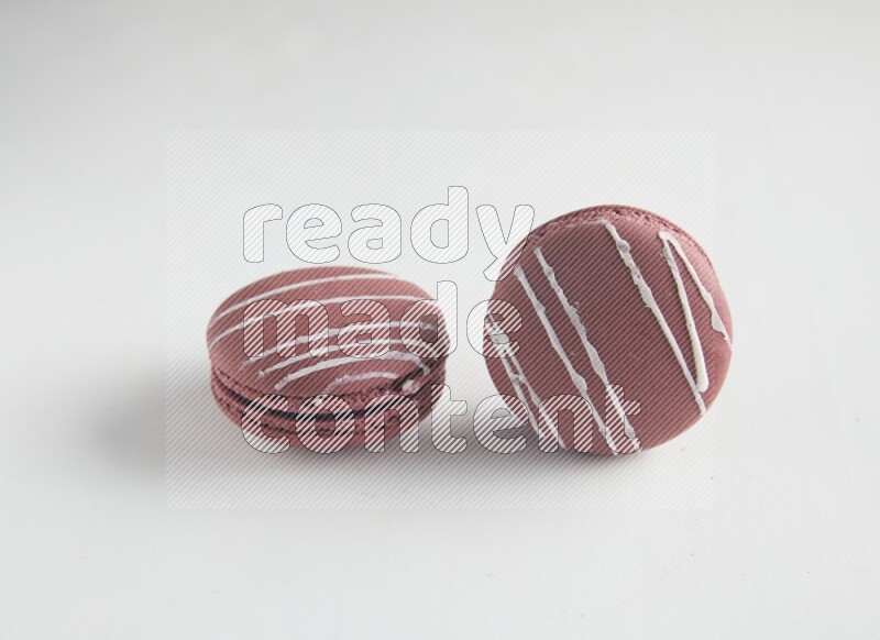 45º Shot of two Red Poppy Flower macarons on white background