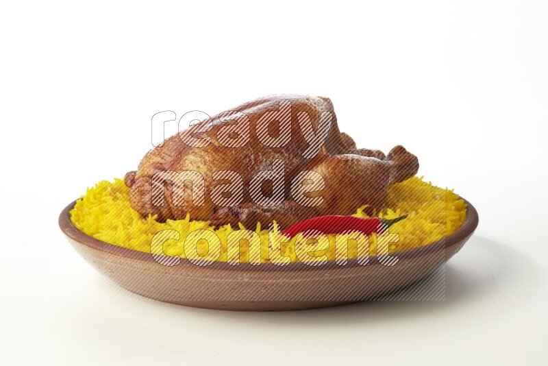 yellow basmati Rice with whole roasted chicken  on a pottery plate  direct  on white background
