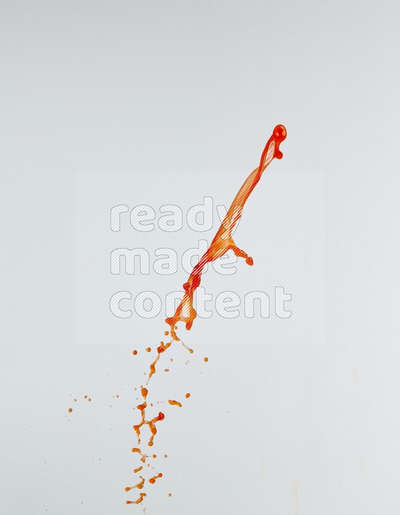 Orange liquid splash and drops on white background