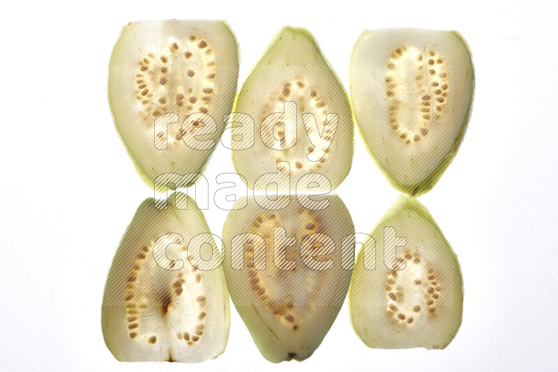 Guava slices on illuminated white background