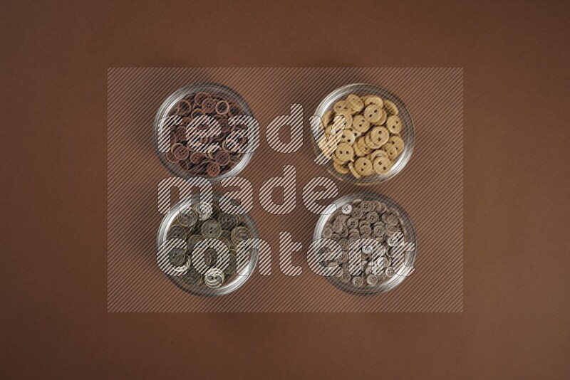 A brown collection of sewing and tailoring tools arranged on a brown background