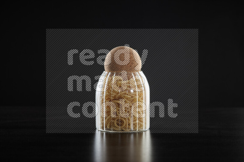Snacks in a glass jar on black background