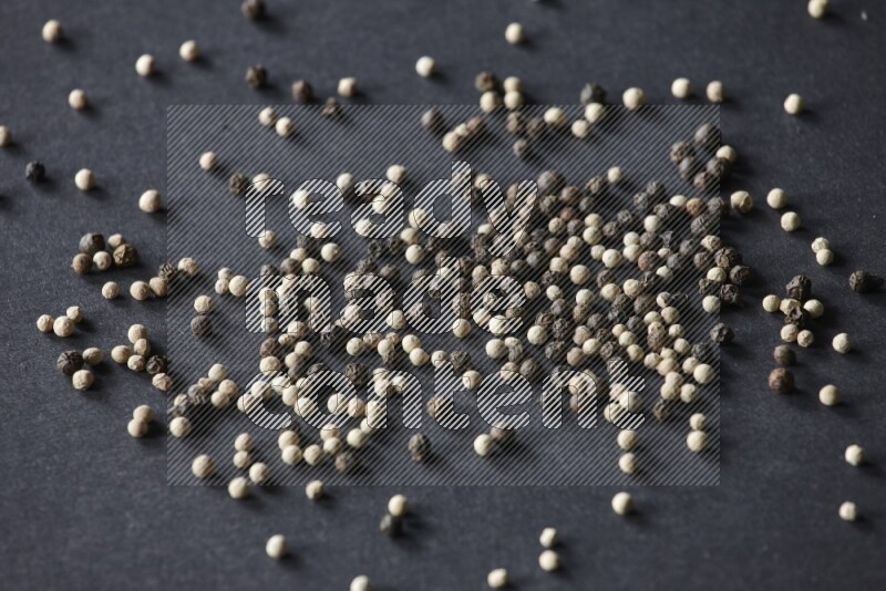 Mixed black and white pepper beads on a black flooring