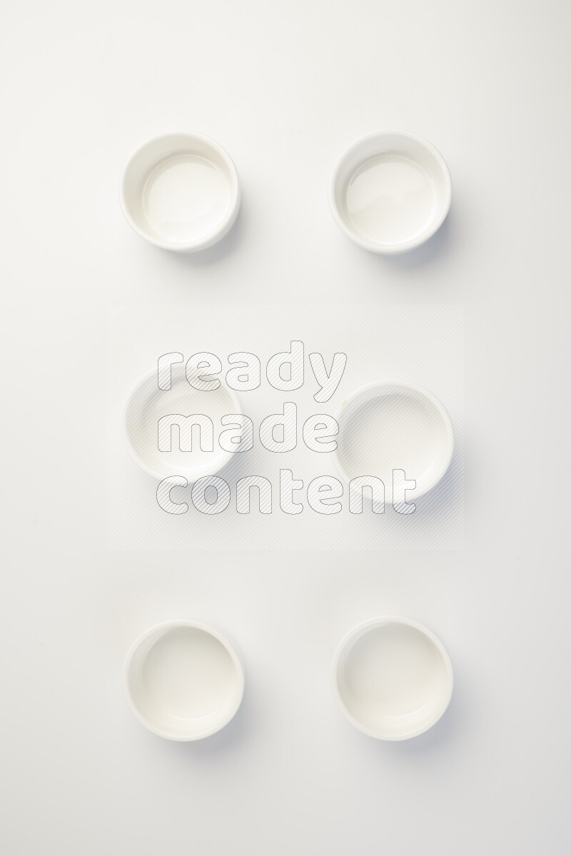 white ceramic round sauce dish on white countertop