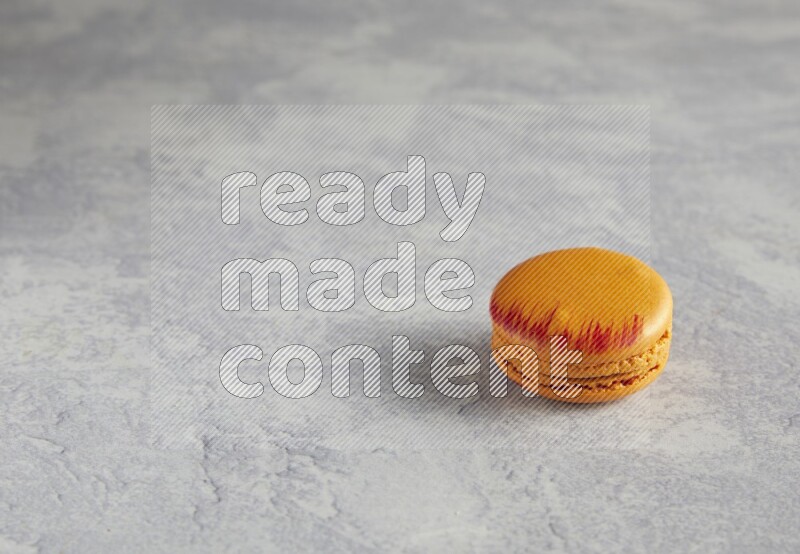 45º Shot of Orange Exotic macaron on white  marble background
