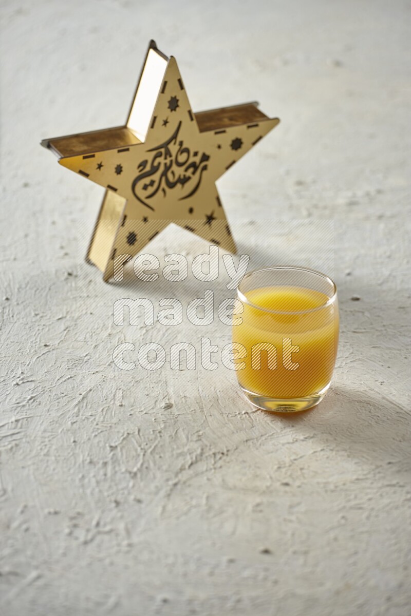 A wooden golden star lantern with different drinks, dates, nuts, prayer beads and quran on textured white background