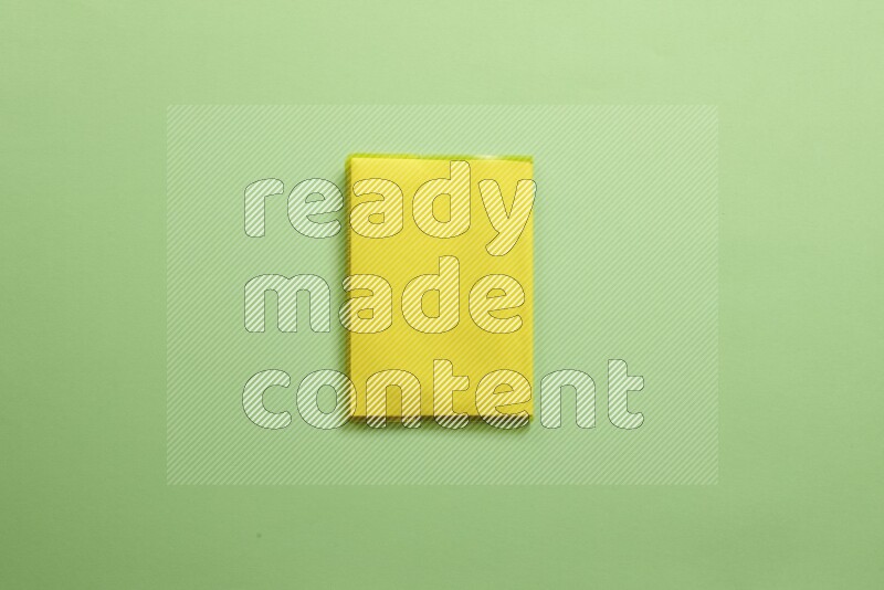 Multicolored notebooks on green background