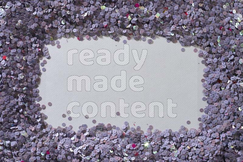 Multicolored flat sequins on grey background