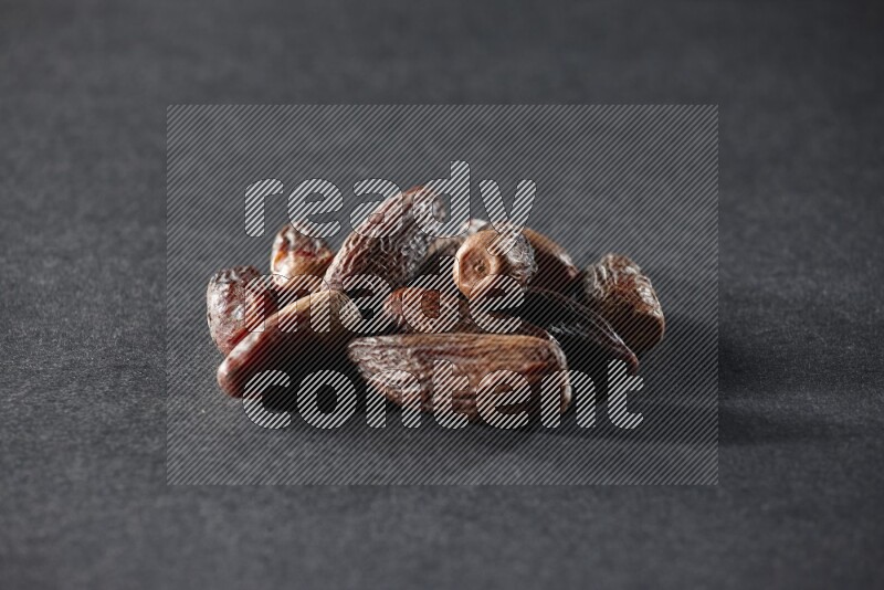 Dried dates on a black background in different angles