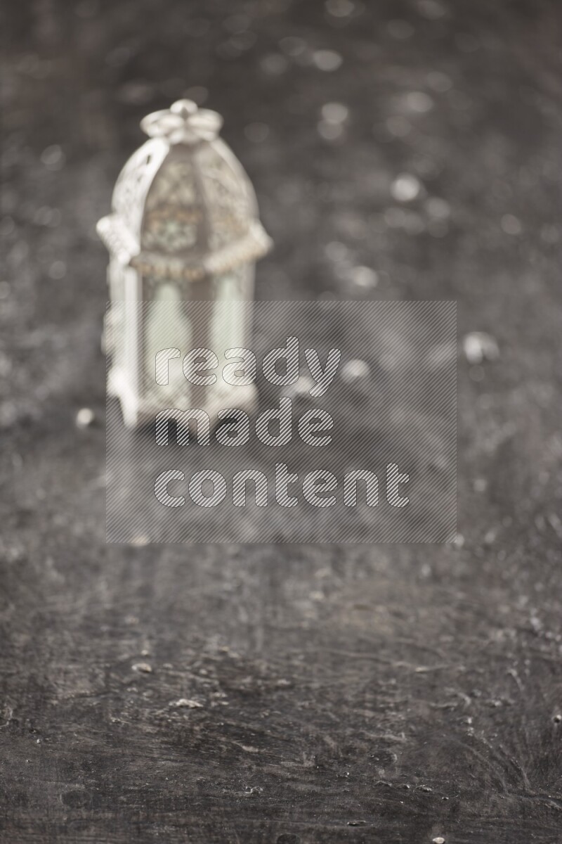 An out of focus lantern on textured black background