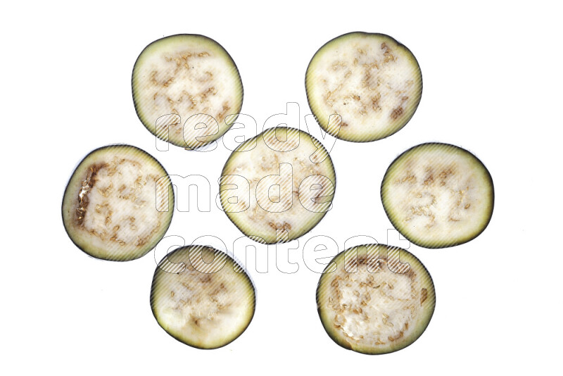 Eggplant slices on illuminated white background