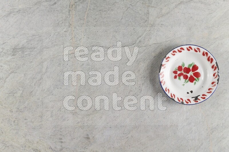A vintage metal plate on grey marble background