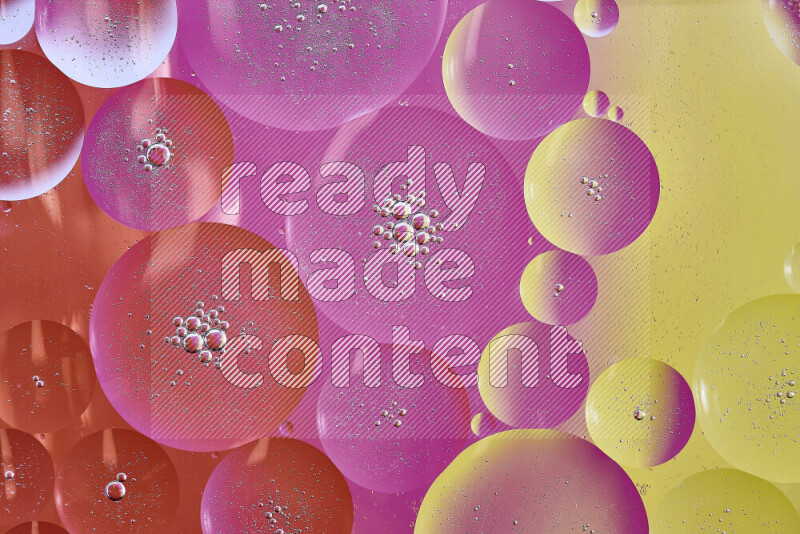 Close-ups of abstract oil bubbles on water surface in shades of yellow, orange and pink