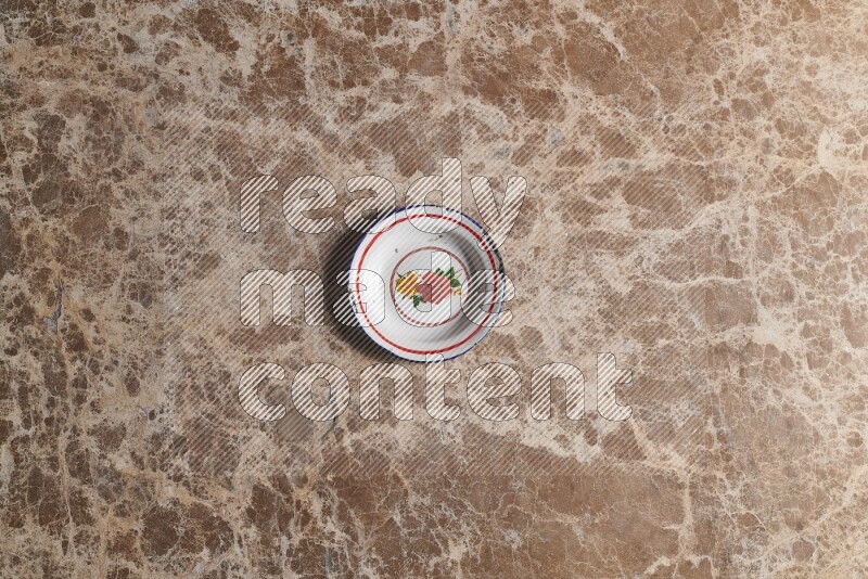 A vintage metal plate on beige marble background