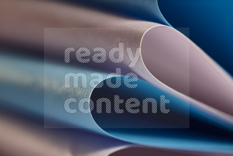 An abstract art showing purple and blue paper sheets arranged in an overlapping curves