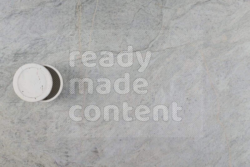 A multicolored pottery Cup on grey marble background