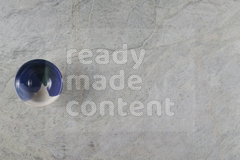 A multicolored pottery Bowl on grey marble background