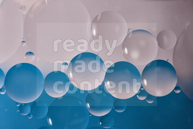 Close-ups of abstract oil bubbles on water surface in shades of white and blue