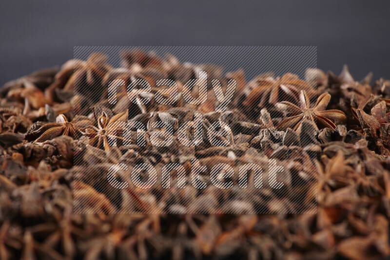 Star Anise fill the frame on black flooring