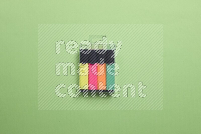 Multicolored highlighter pens on green background